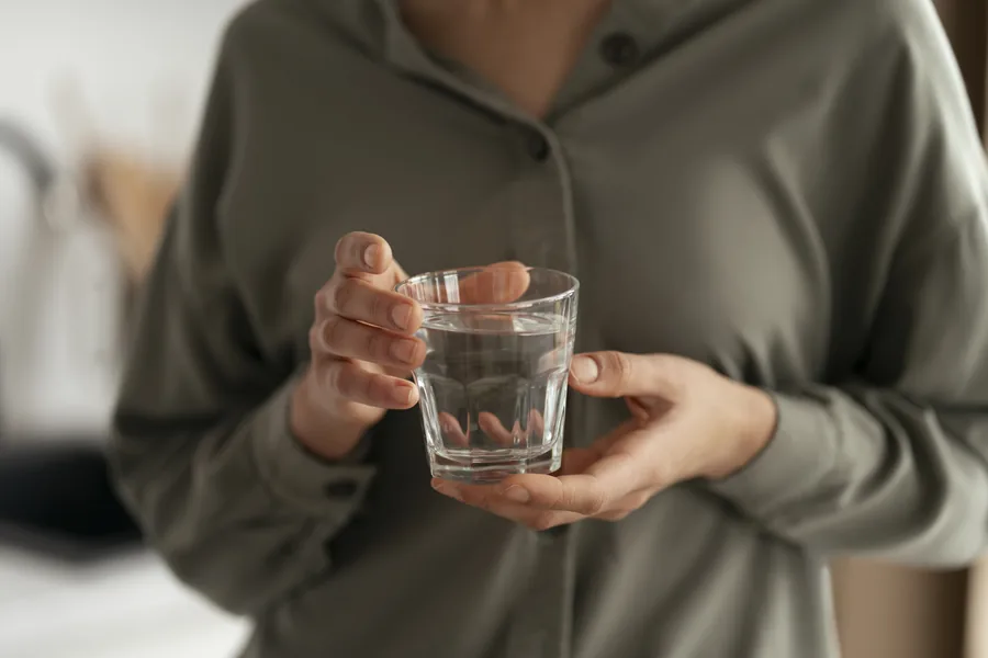 A pause during the day, holding a glass of water