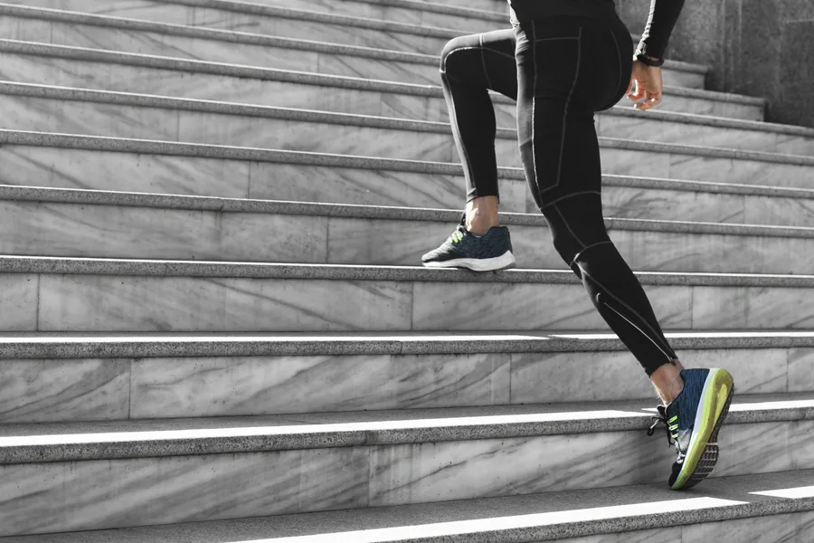 Someone partway up a flight of stairs